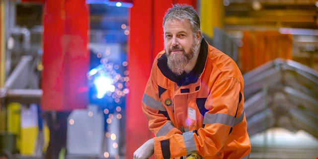 Person i arbetskläder i industrimiljö.